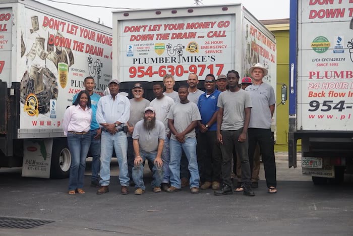 The full Plumber Mike's crew in front of the trucks