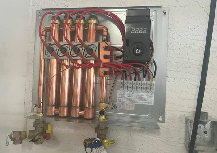 Inside of an electric tankless water heater with copper heating elements